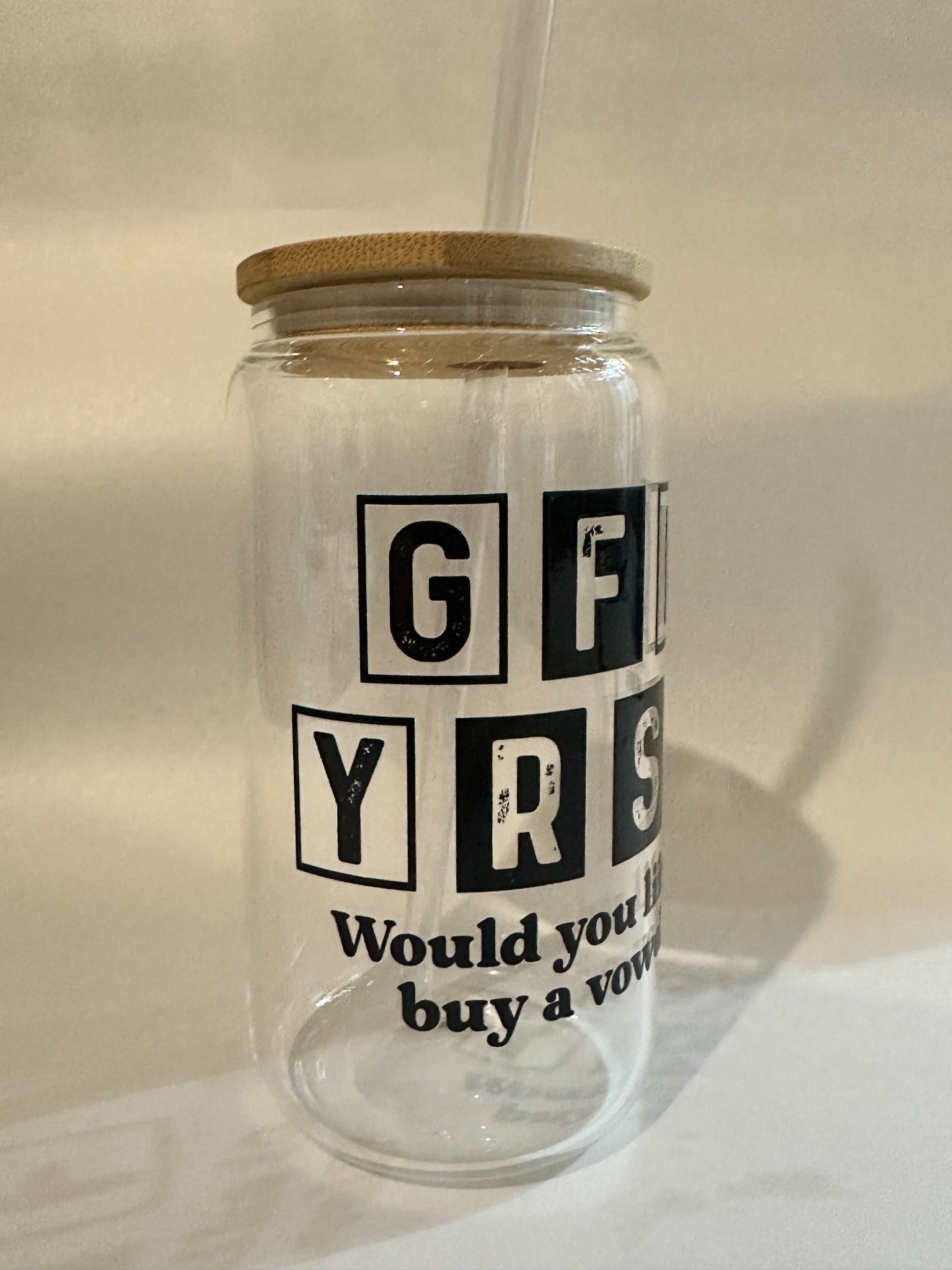 Side view of 15oz Libby glass with black distressed block letters and bamboo lid.