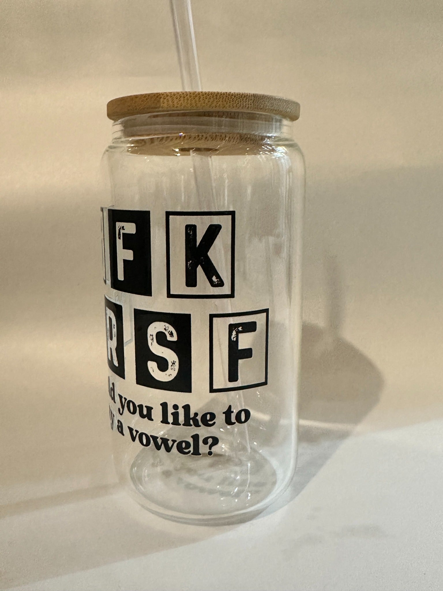 Side view of 15oz Libby glass with black distressed block letters and bamboo lid.