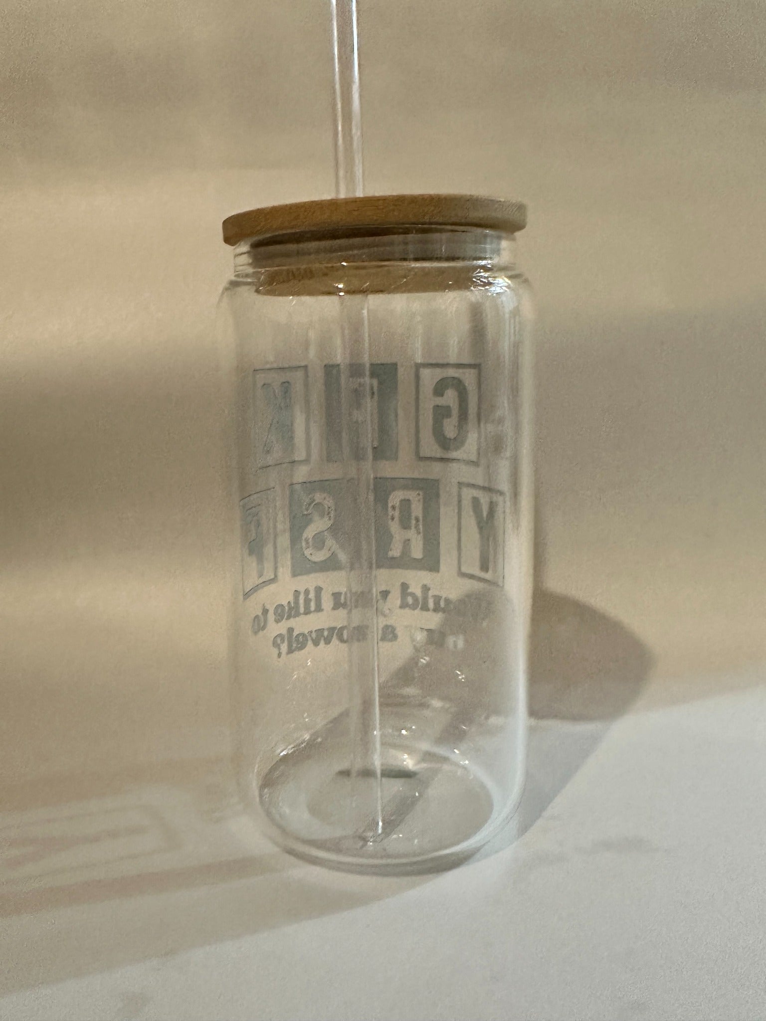 Back view of block-letter design on 15oz Libby glass with straw inserted.